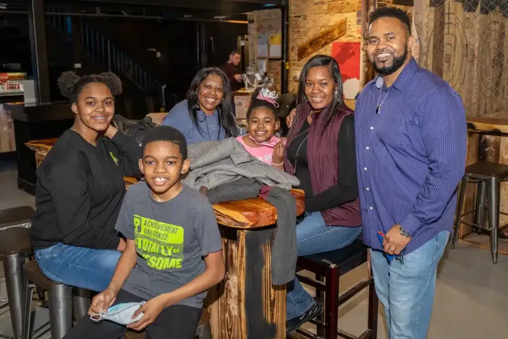 Family celebrating a birthday with axe throwing in Graham